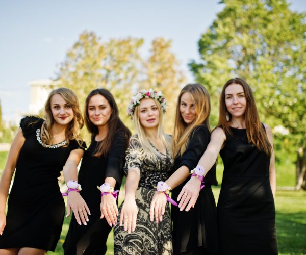 Five girls wear on black having fun at hen party.